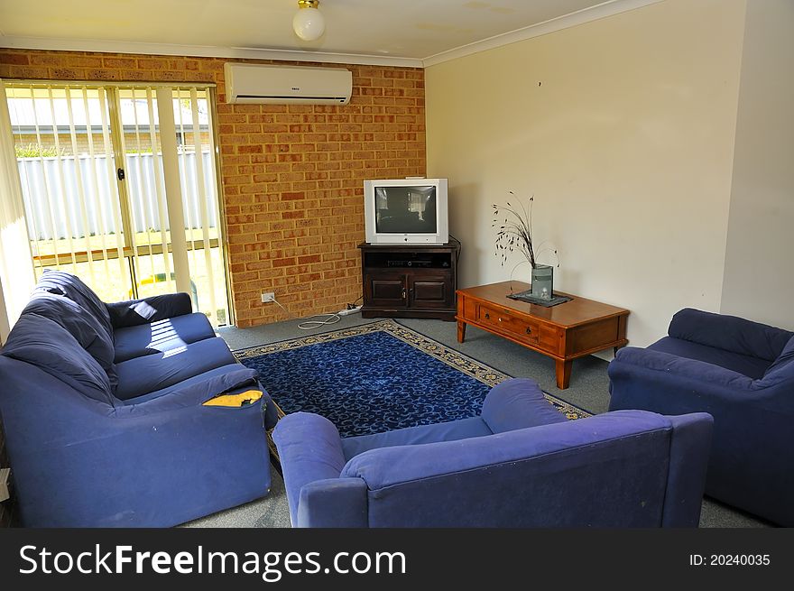 Interior of simple commong room with sofa and television. Interior of simple commong room with sofa and television.