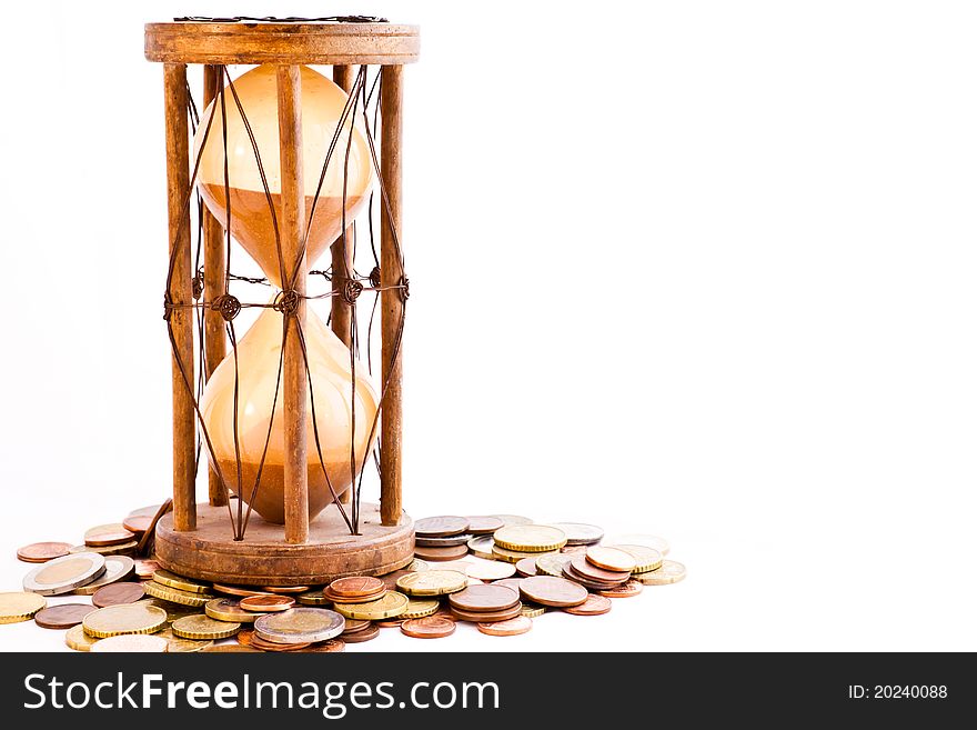 Old hourglass (made in India, XIX century) with euros. Old hourglass (made in India, XIX century) with euros