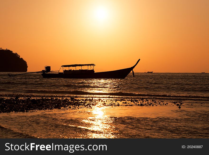 Longtail boat and sunset on Railay island, Krabi, Thailand