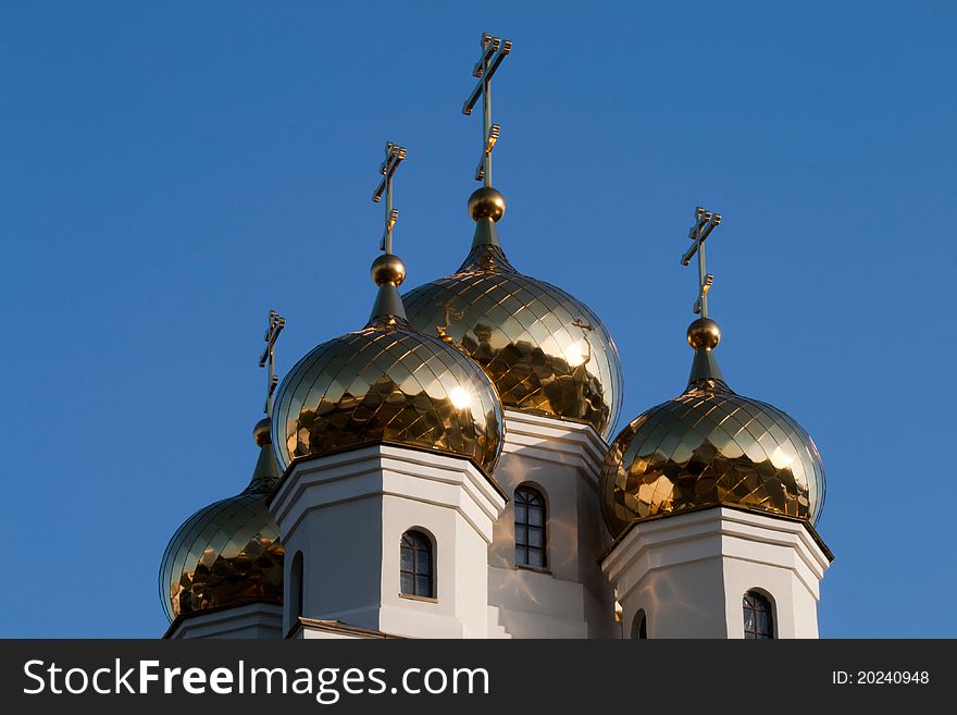 Four golden domes of the Orthodox Church against the blue sky. Four golden domes of the Orthodox Church against the blue sky