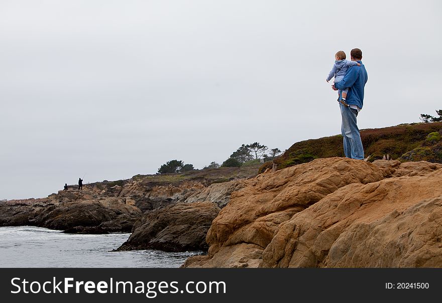 Father and son looking at the ocean