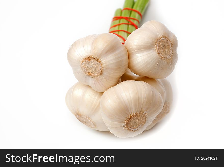 Several heads of garlic on a white background