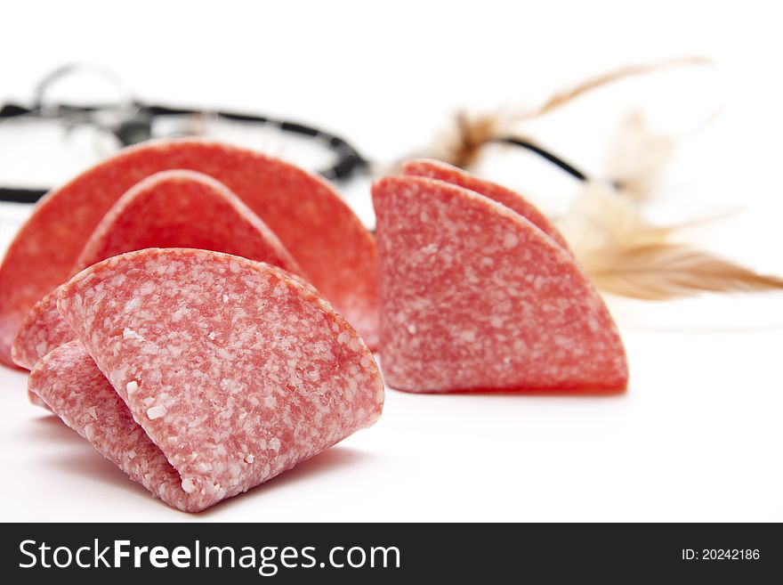 Salami folded onto white background