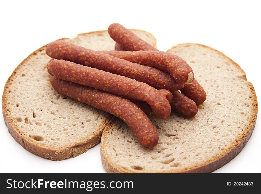 Mead sausage with bread onto white background