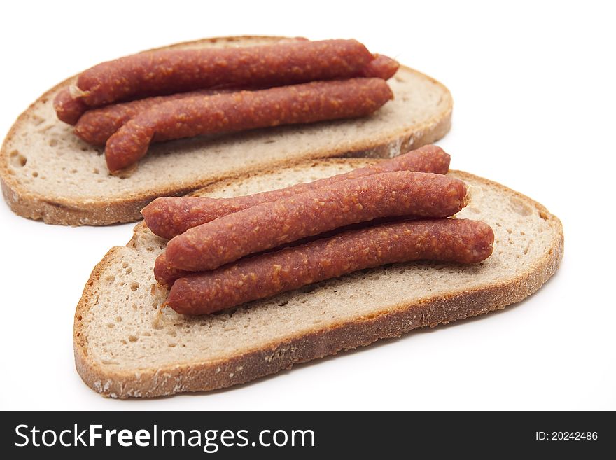 Mead sausage with bread onto white background