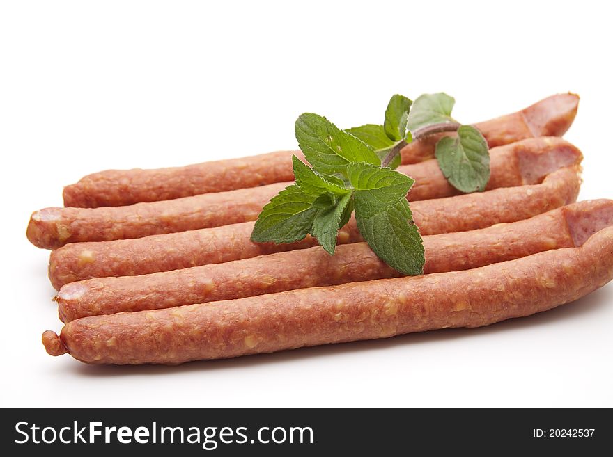 Mead sausage with mint onto white background
