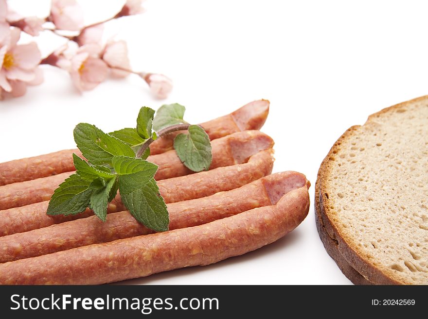 Mead sausage with bread and mint onto white background. Mead sausage with bread and mint onto white background