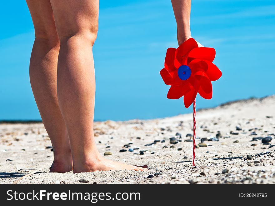 Red Wind Turbine On The Beach