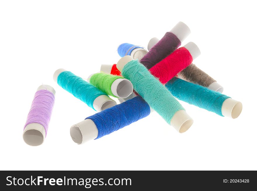 Multicolored spools of thread isolated on a white background