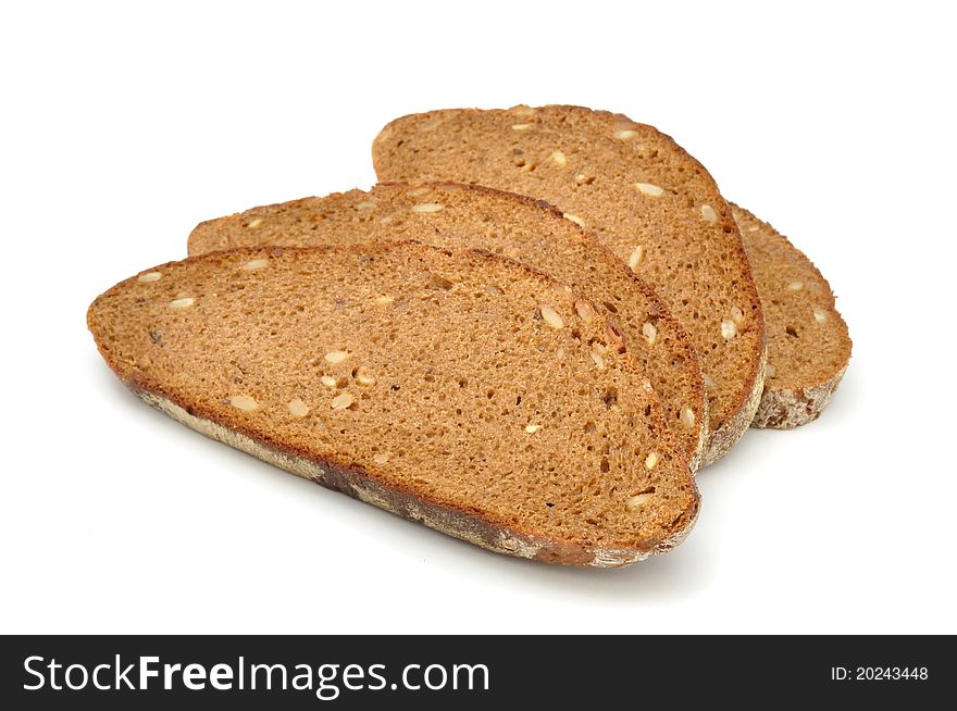 Sliced brown bread with sunflower seeds isolated on a white background