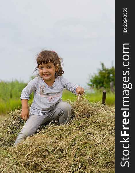 Girl sits on the hay. Girl sits on the hay