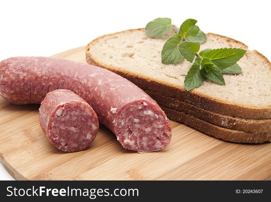 Garlic salami with bread onto wood plates