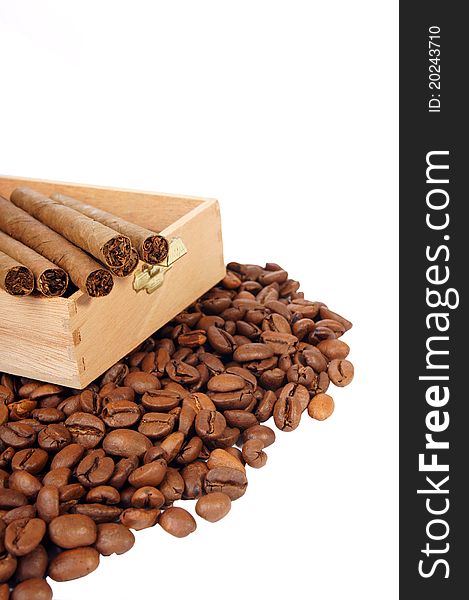 Many coffee beans and cigarettes of a white background