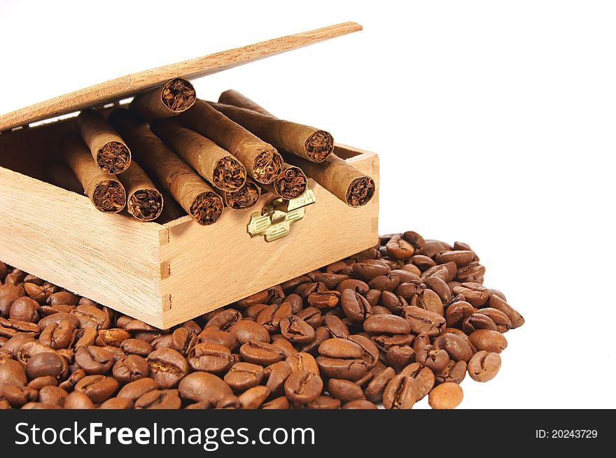 Many coffee beans and cigarettes of a white background
