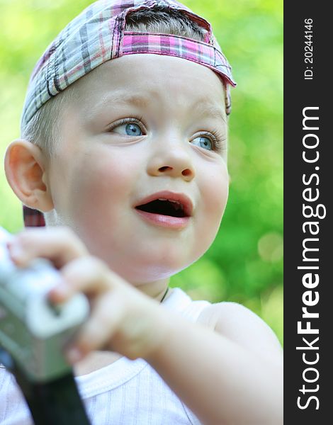 A baby boy playing outdoors