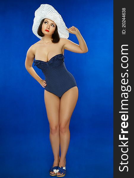 The girl in a bathing suit on a dark blue background