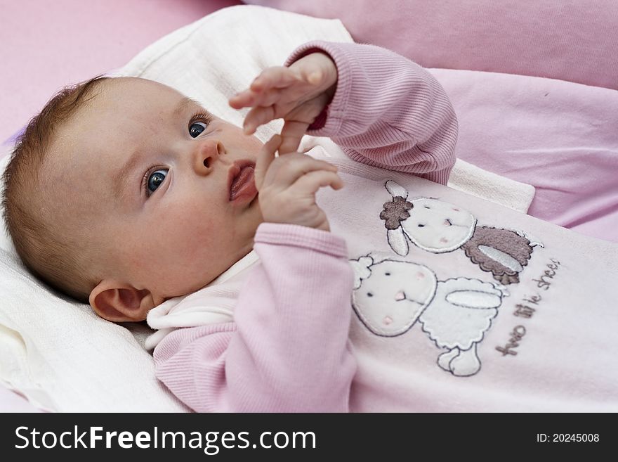 Small baby playing with hands and fingers, counting fingers