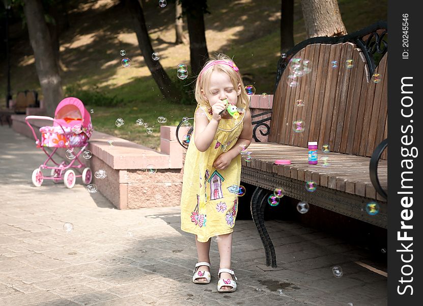 Little happy girl at the summer park