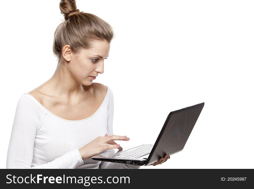 Young female working on laptop isolated on white background