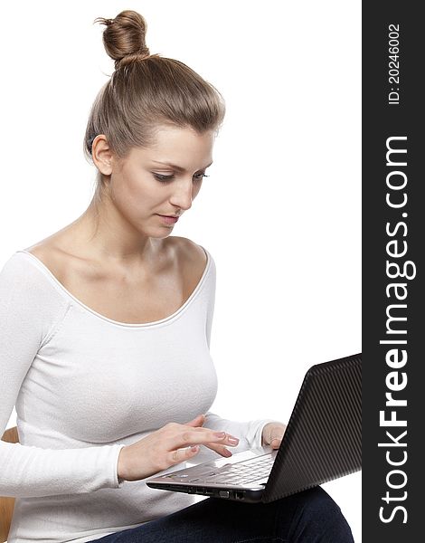 Young female working on laptop isolated on white background