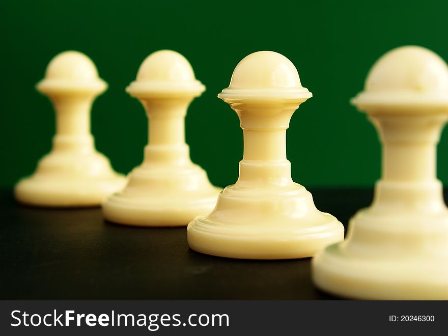 Pawn located in a row on a green background. Pawn located in a row on a green background