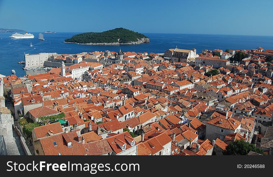 A photograph of a cruise liner and a sailboat outside the ancient city of Dubrovnik in Croatia. A photograph of a cruise liner and a sailboat outside the ancient city of Dubrovnik in Croatia