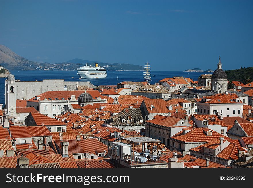 A photograph of a cruise liner and a sailboat outside the ancient city of Dubrovnik in Croatia. A photograph of a cruise liner and a sailboat outside the ancient city of Dubrovnik in Croatia