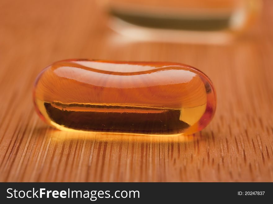 Medical pill against diseases on a wooden table.