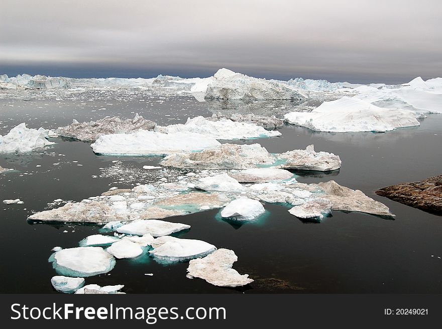 Floating icebergs and ice fjord near Illulisat, Greenland