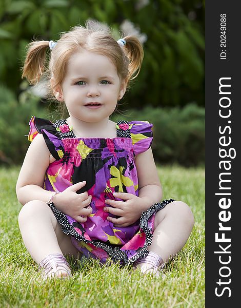 A young girl poses outside