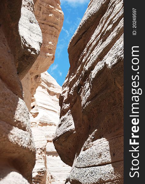 The trail winds between two, rough sandstone walls en route to New Mexico's Tent Rocks National Monument. The trail winds between two, rough sandstone walls en route to New Mexico's Tent Rocks National Monument.