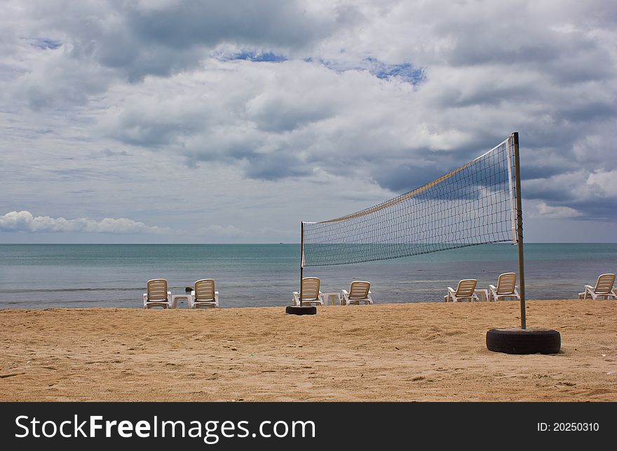 Volleyball net on and beach chair. Volleyball net on and beach chair