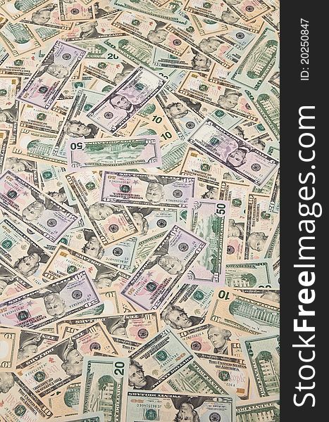 The background of U.S. dollars. Many bills of different denominations. The background of U.S. dollars. Many bills of different denominations