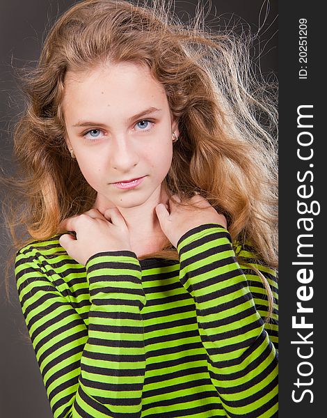 Portrait of happy girl teenager in studio