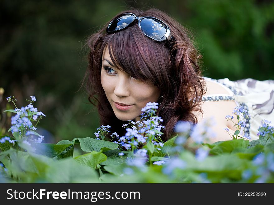 Tender girl in the garden with flowers