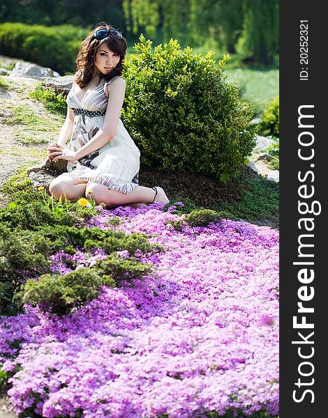 Tender girl in the garden with flowers