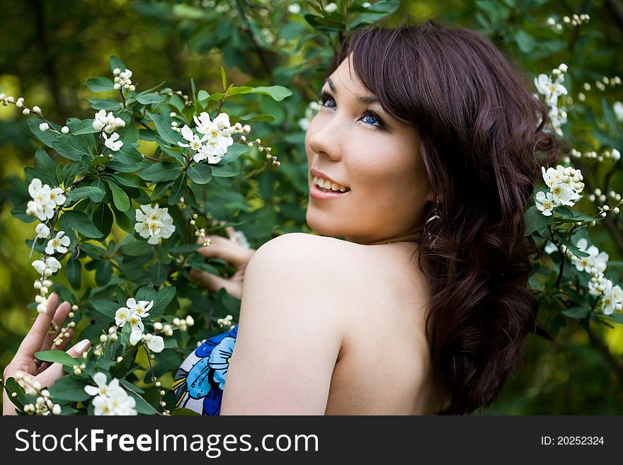 Tender girl in the garden with flowerings trees