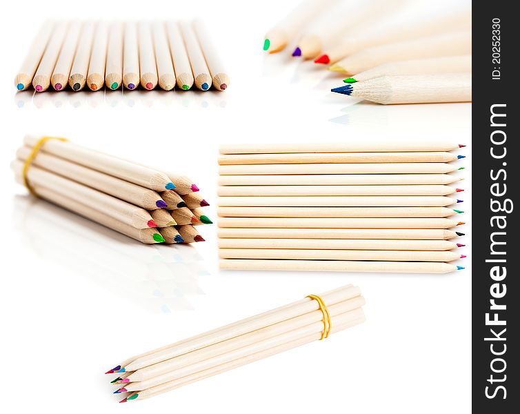 Many colored pencils in row over white background