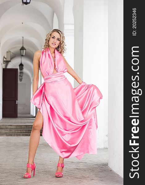 Beautiful fashionable woman in pink dress