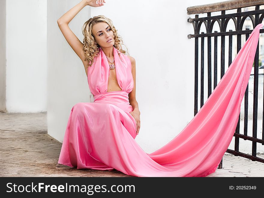 Beautiful fashionable woman in pink dress
