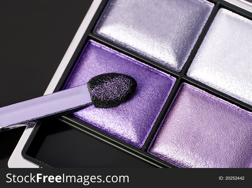 Make-up eyeshadows and cosmetic brush