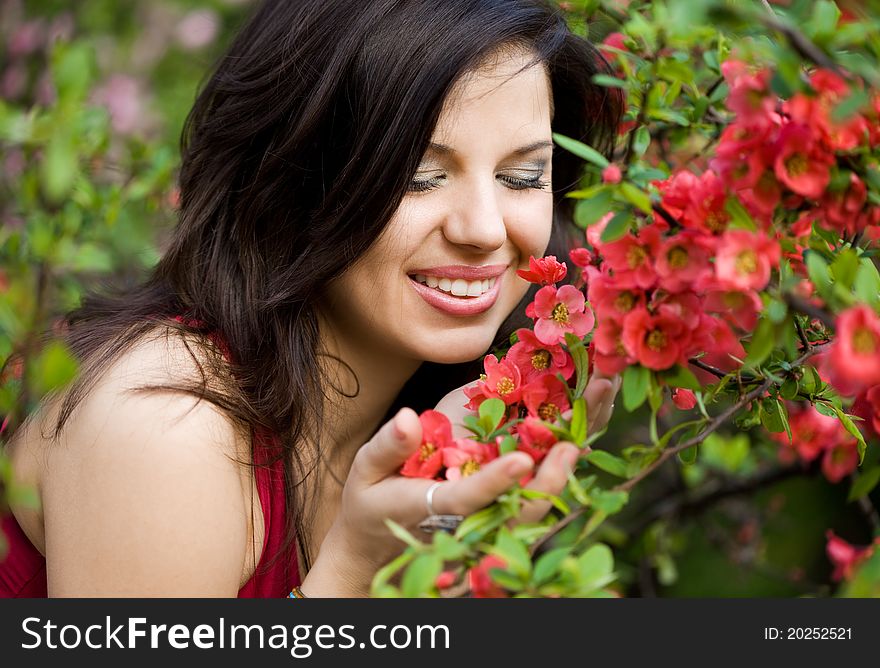 Woman in garden with red flowers