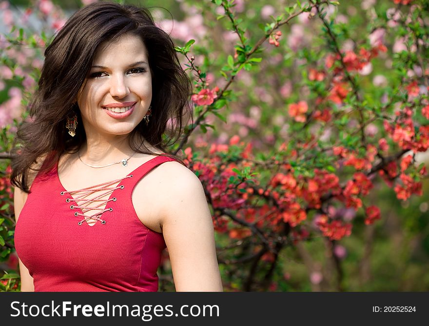 Woman in garden with pink flowers