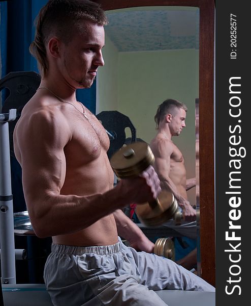 Muscled male model with  free weights. Muscled male model with  free weights