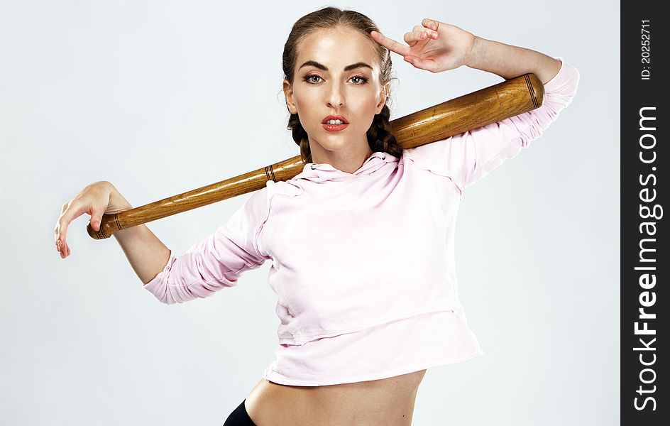 Pretty lady with a baseball bat, studio portrait