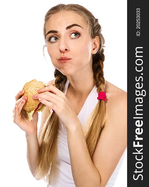 Young woman holding a hamburger and an apple, white background