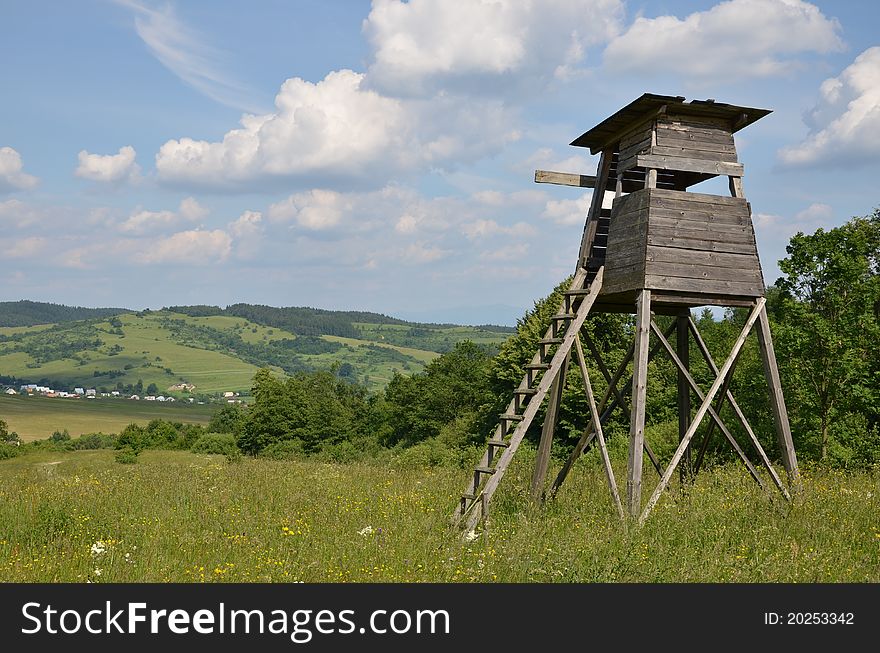 There is a hunting tower in the meadow