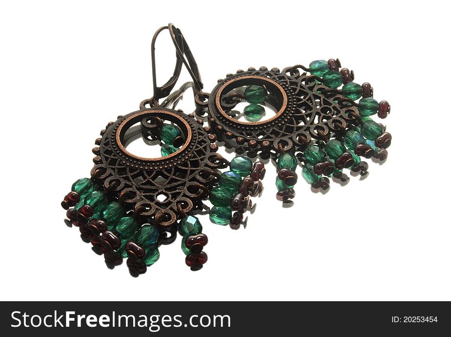 Isolated macro of handmade earrings with gemstones in gipsy style