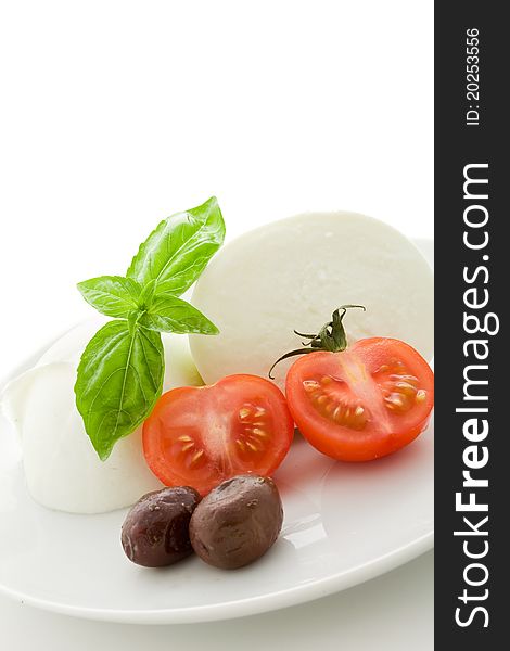 Deliciious buffalo mozzarella with cutted cherry tomatoes on white isolated backgroundl. Deliciious buffalo mozzarella with cutted cherry tomatoes on white isolated backgroundl