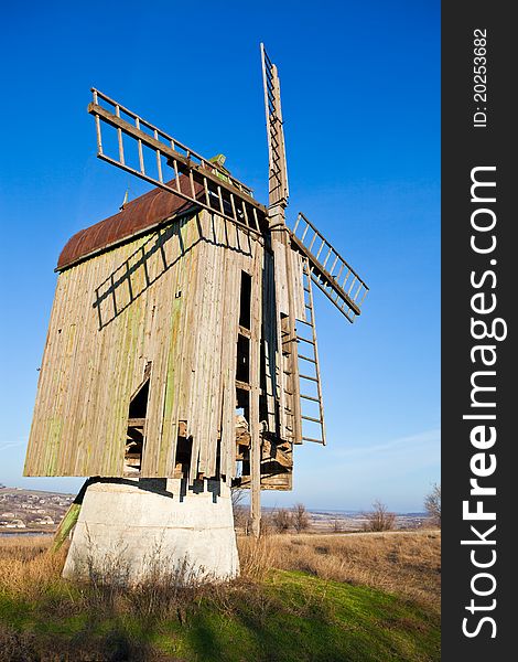 Wooden old windmill on a blue sky